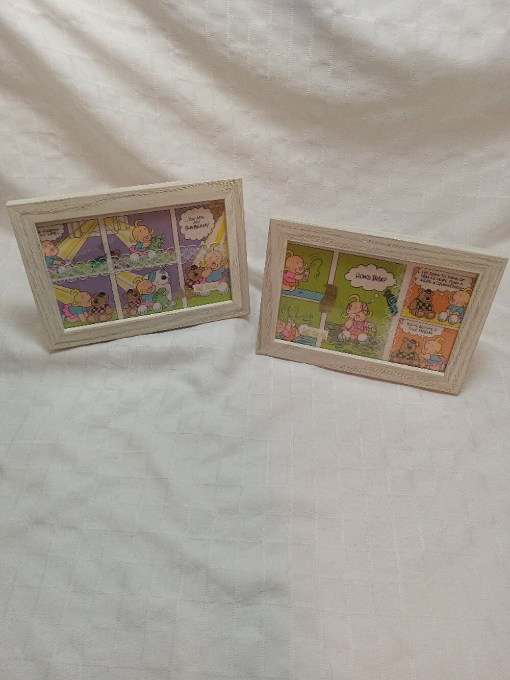 A set of delicate picture frames for a baby's room with vintage wrapping paper